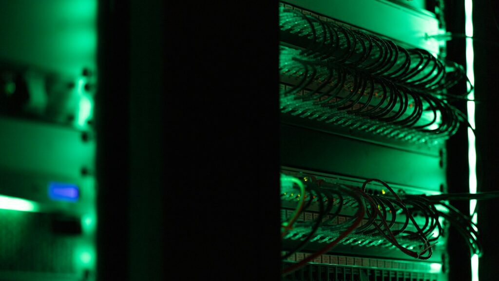 Dark server room illustrating a Nexon, TiviOne and Crystal IPTV reseller panel comparison