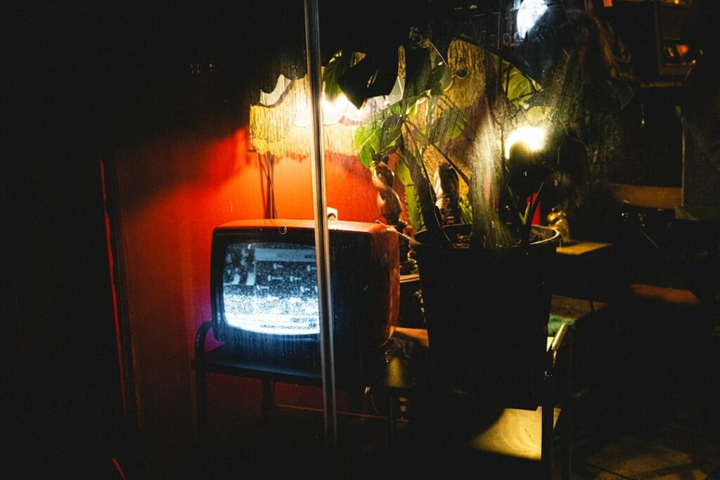 Glowing television in a dark room illustrating a live PPV event channel check