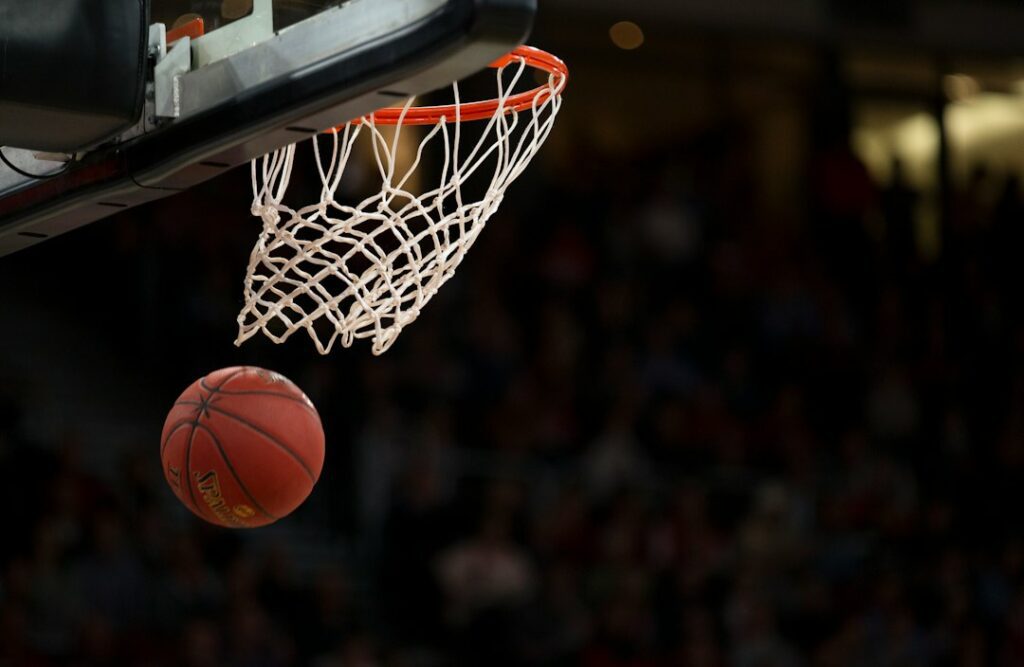 Basketball player in an arena representing live sports blackout troubleshooting