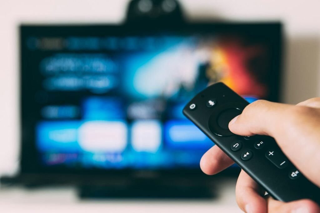 Television screen in a dark room, illustrating a video-on-demand catalogue availability guide